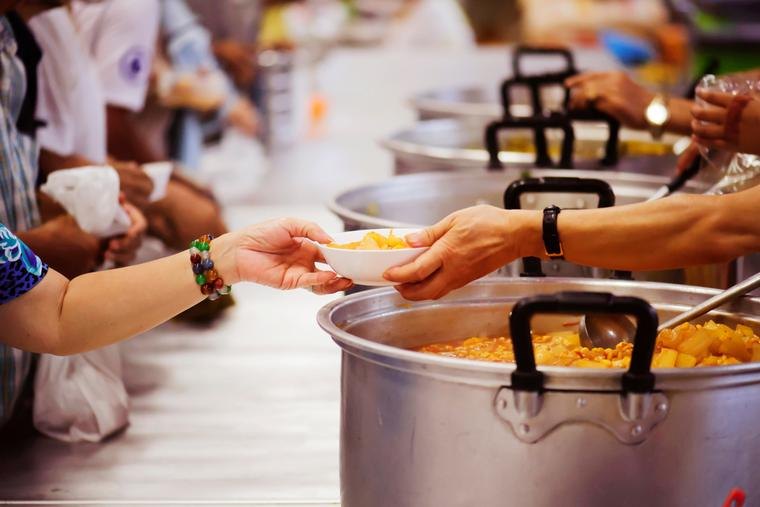 Volunteers serving warm meals to families